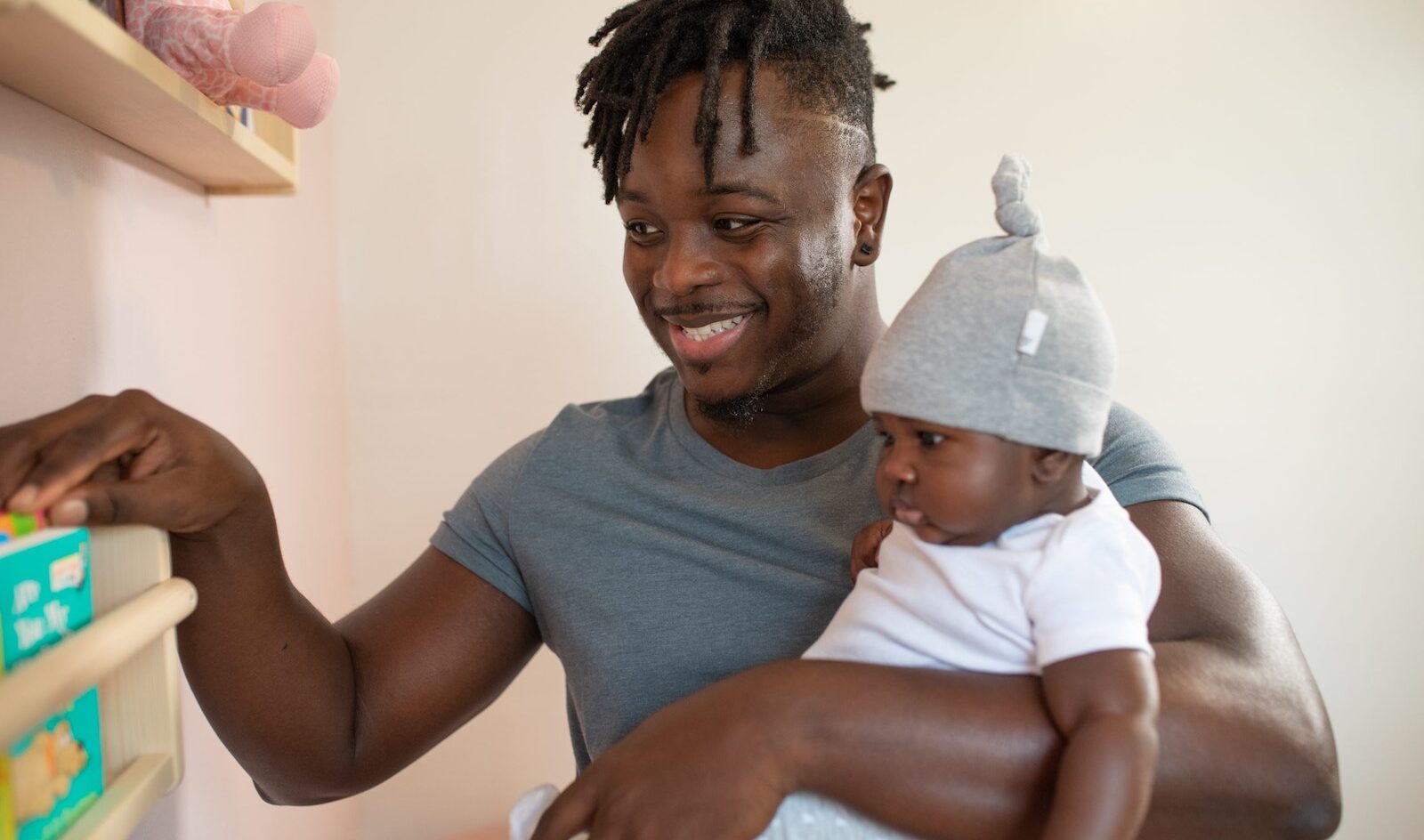 A Smiling Man Carrying His Baby