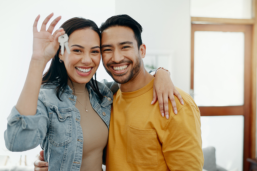 New home keys, hug and portrait of happy couple moving into house, real estate property or apartment purchase. Love, homeowner smile and Mexican man, woman or relocation people embrace in living room