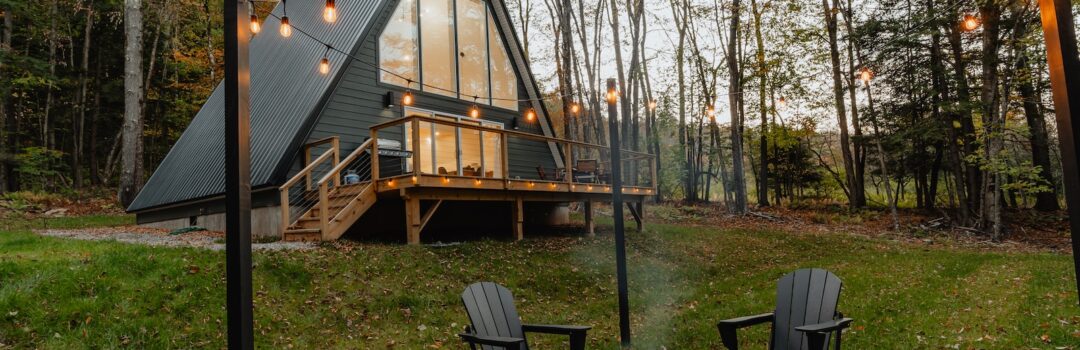 a small cabin with a fire pit in the yard