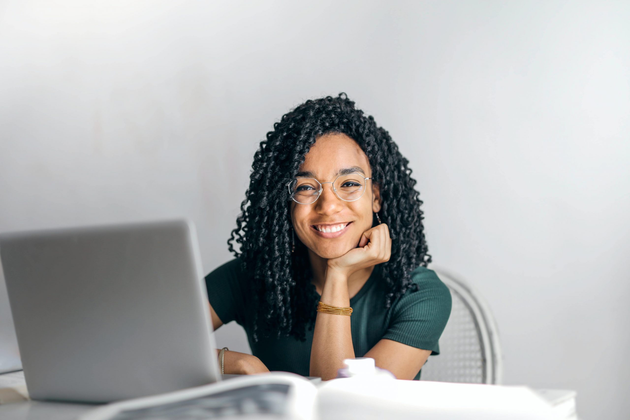 girl smiling while working on laptop